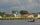 People in a small boat on the Kapuas River beside a West Borneo waterfront