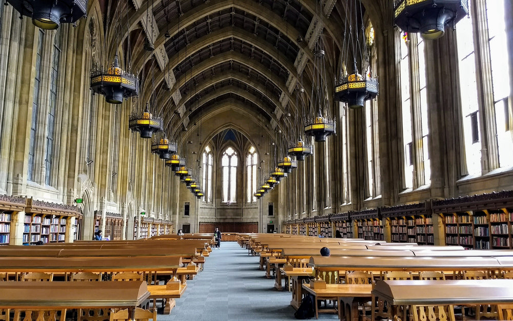 Suzzallo Library reading room with long study tables and bookshelves