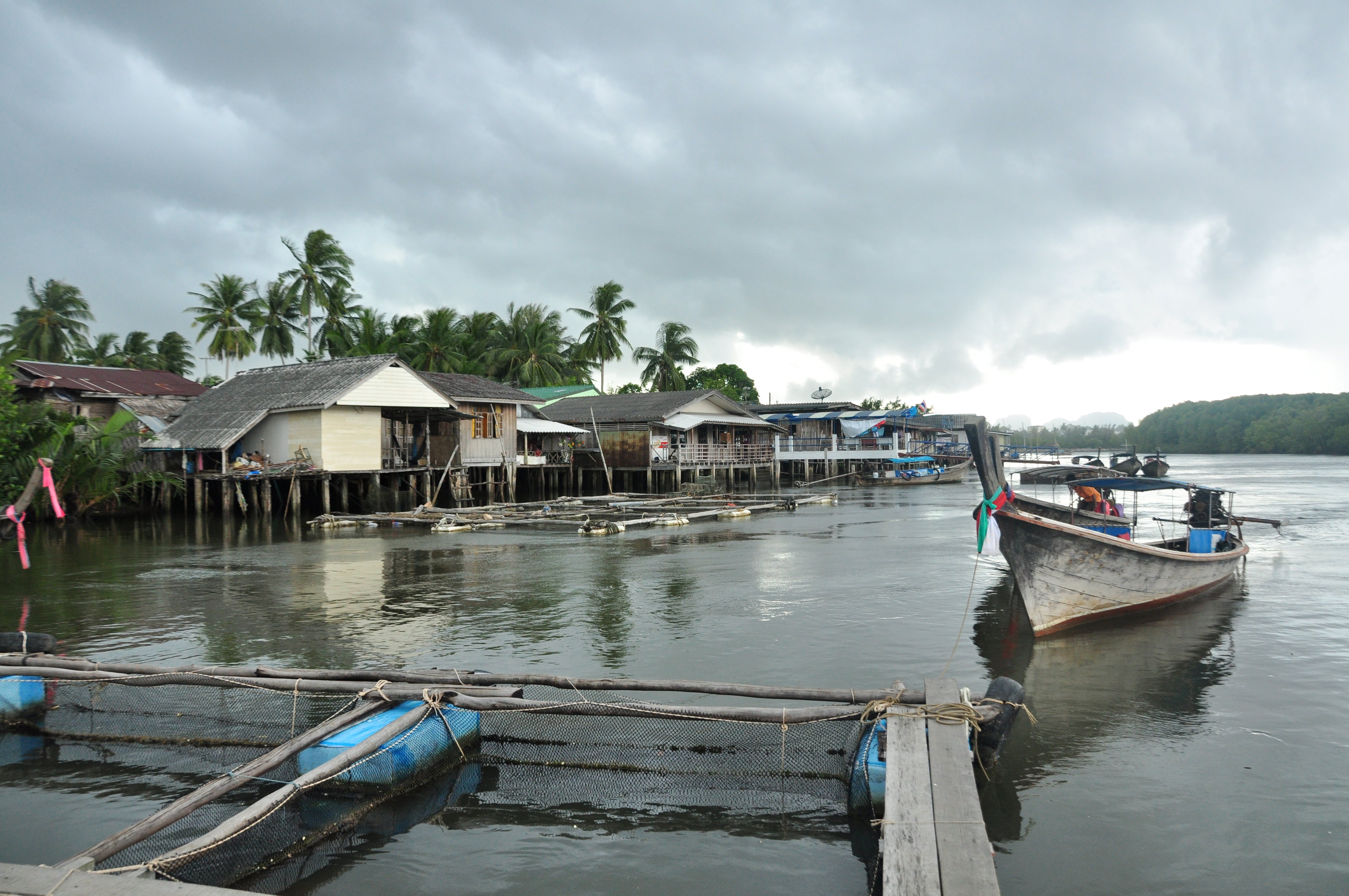 Fishing village and long-tail boat on a river near Krabi in southern Thailand